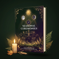 Seasonal Ceremonies hardcover guide standing among ferns beside a lit candle, with dried leaves at its base